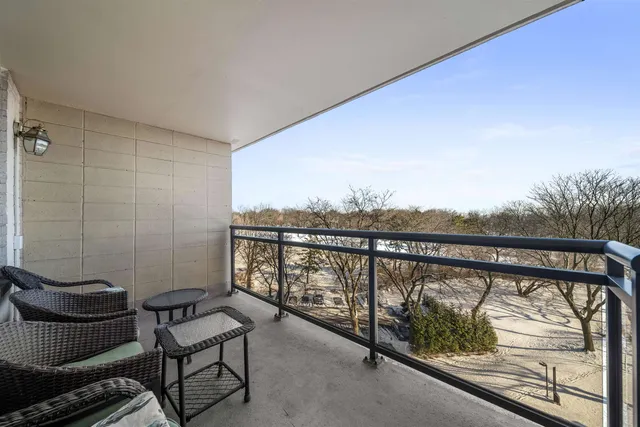 a view of a balcony with furniture
