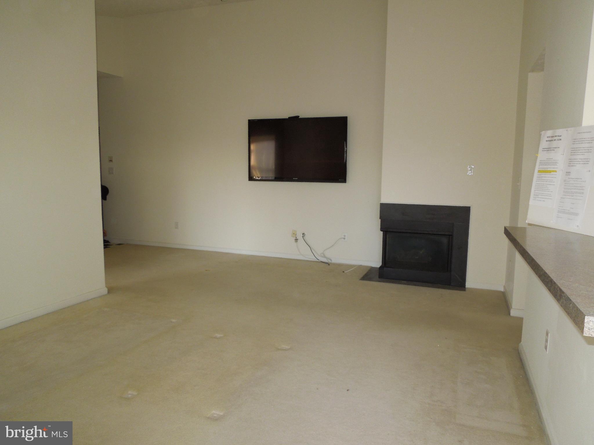 8233 Poplar Mill Road Baltimore, MD 21236 - Photo 4 of 20 Living room with vaulted ceiling and gas fireplace