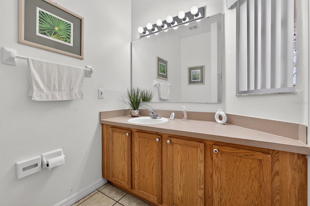 1066 Park Ridge Circle Kissimmee, FL 34746 - Photo 29 of 49 a bathroom with a sink and a mirror