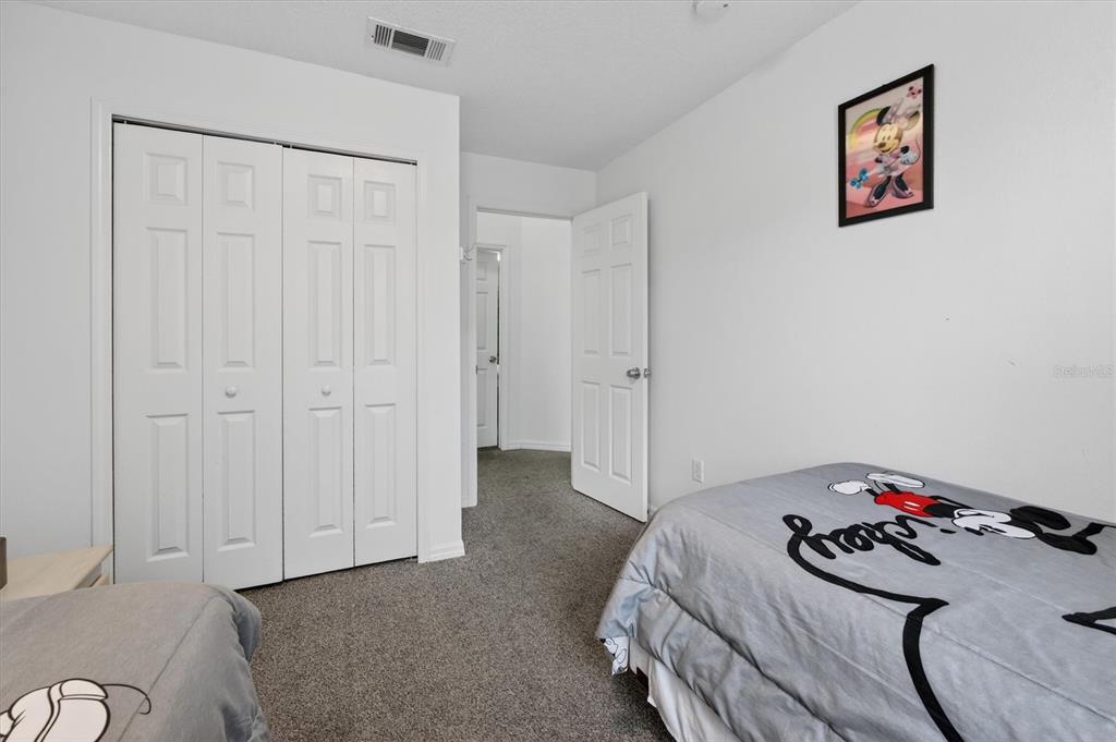 1066 Park Ridge Circle Kissimmee, FL 34746 - Photo 30 of 49 a bedroom with a bed and a dresser