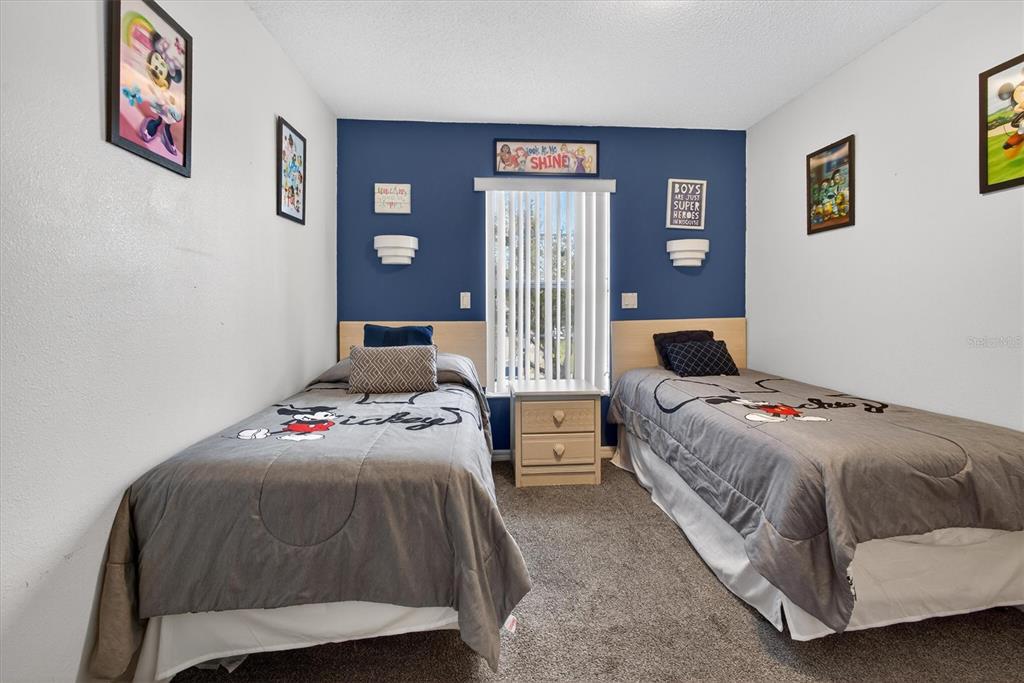 1066 Park Ridge Circle Kissimmee, FL 34746 - Photo 31 of 49 a bedroom with a bed and wooden floor