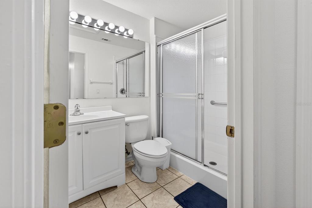 1066 Park Ridge Circle Kissimmee, FL 34746 - Photo 33 of 49 a bathroom with a granite countertop toilet a sink and a mirror