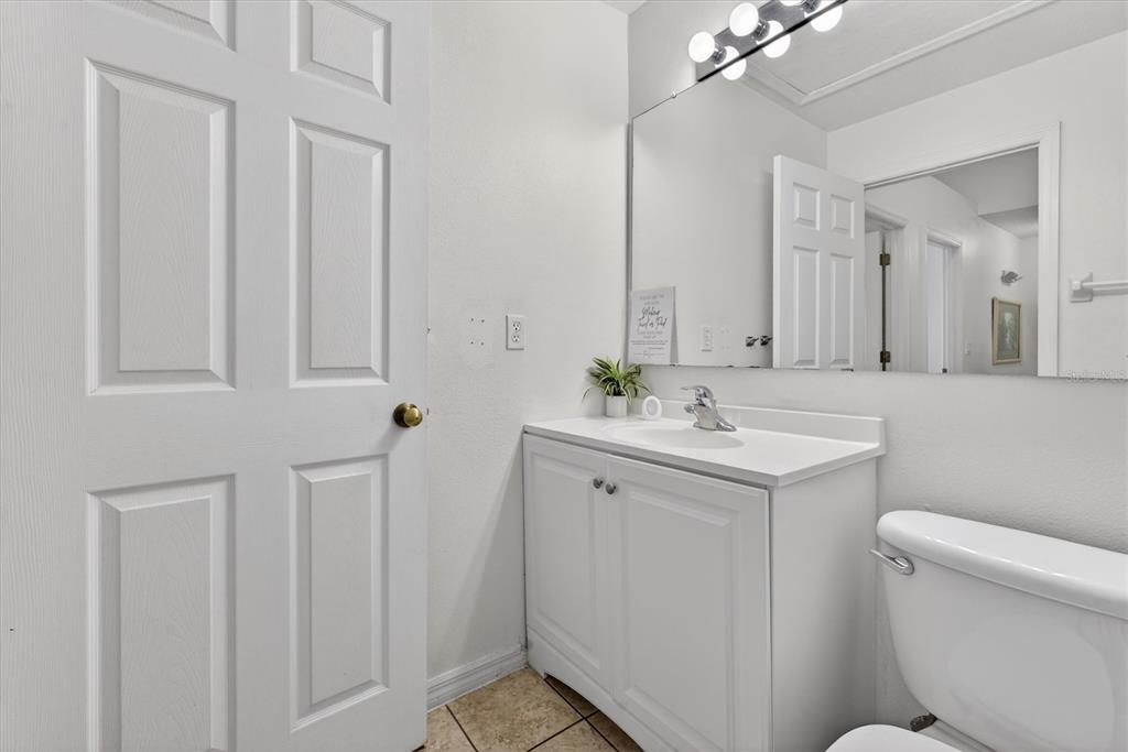 1066 Park Ridge Circle Kissimmee, FL 34746 - Photo 34 of 49 a bathroom with a toilet sink and mirror