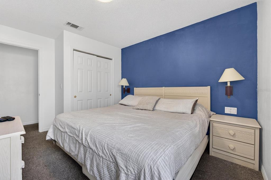 1066 Park Ridge Circle Kissimmee, FL 34746 - Photo 36 of 49 a bedroom with a bed and a lamp