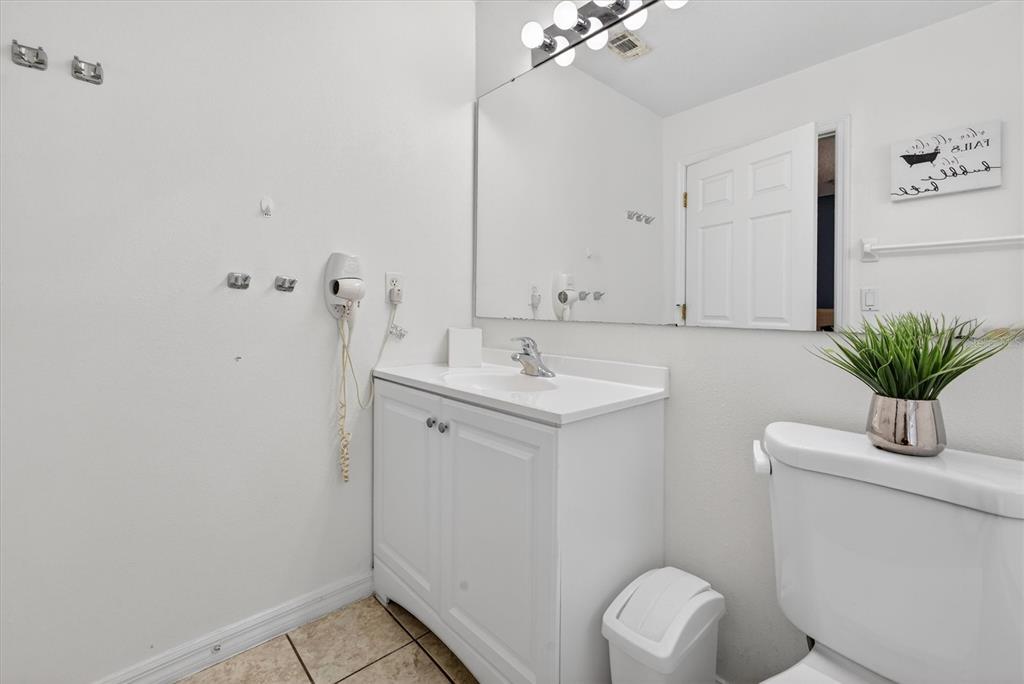 1066 Park Ridge Circle Kissimmee, FL 34746 - Photo 38 of 49 a bathroom with a sink a toilet and mirror