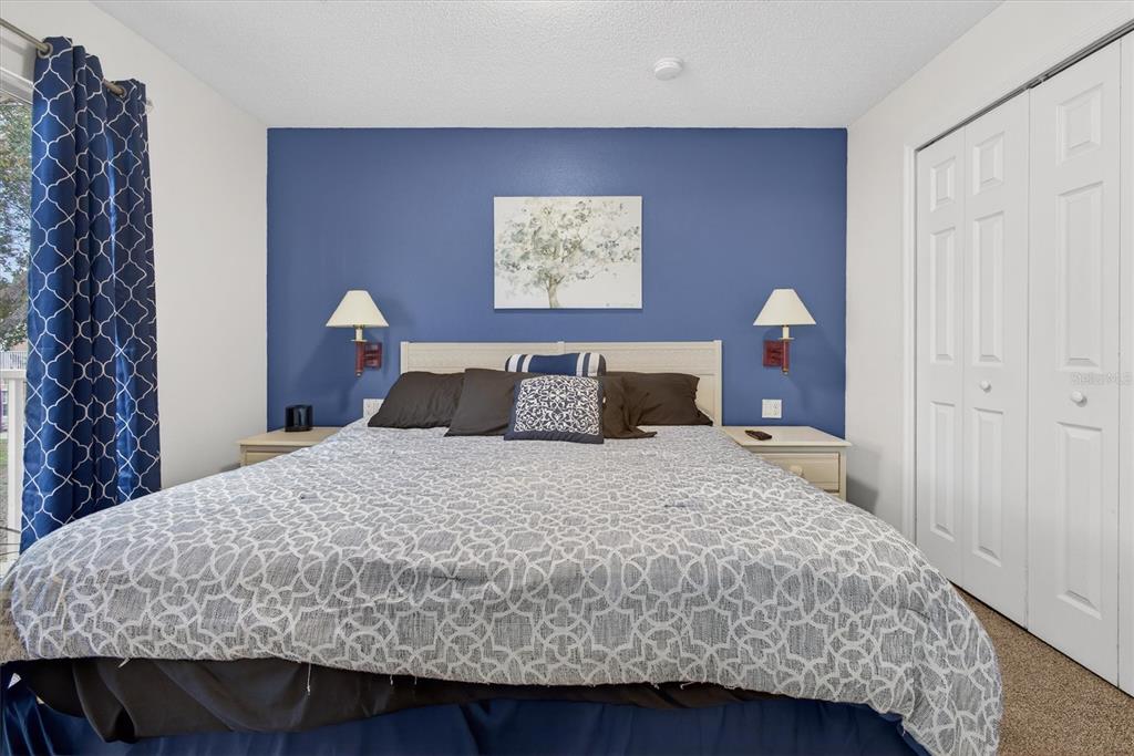 1066 Park Ridge Circle Kissimmee, FL 34746 - Photo 40 of 49 a bedroom with a bed and painting on the wall