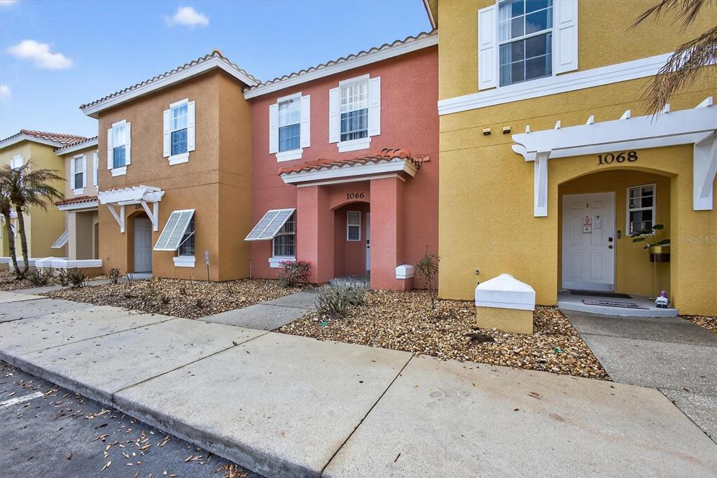 1066 Park Ridge Circle Kissimmee, FL 34746 - Photo 4 of 49 a front view of a house with garden