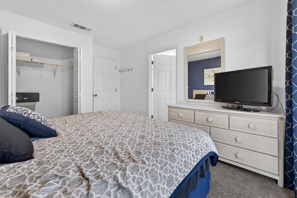 1066 Park Ridge Circle Kissimmee, FL 34746 - Photo 41 of 49 a bedroom with a bed and a flat screen tv in white walls