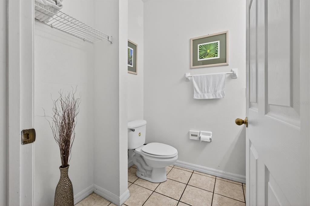 1066 Park Ridge Circle Kissimmee, FL 34746 - Photo 44 of 49 a bathroom with a toilet and a shower curtain