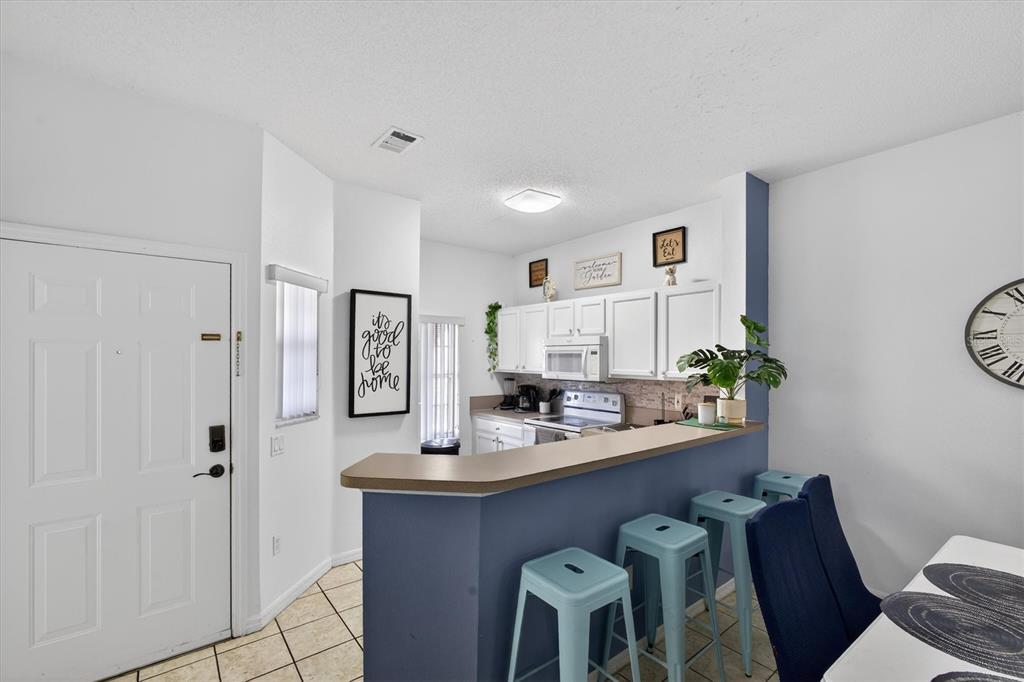 1066 Park Ridge Circle Kissimmee, FL 34746 - Photo 6 of 49 a dining room with furniture and window