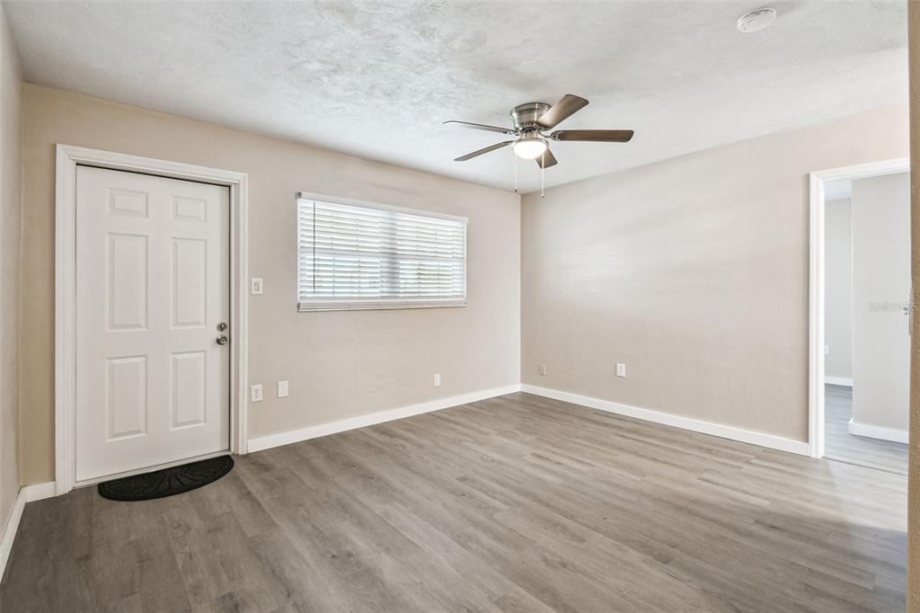 337 4th Street West, Unit A Palmetto, FL 34221 - Photo 11 of 25 an empty room with wooden floor fan and windows