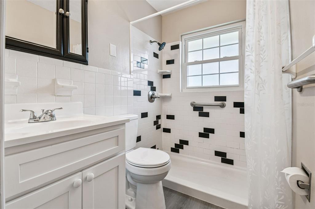 337 4th Street West, Unit A Palmetto, FL 34221 - Photo 18 of 25 a bathroom with a sink a toilet and shower