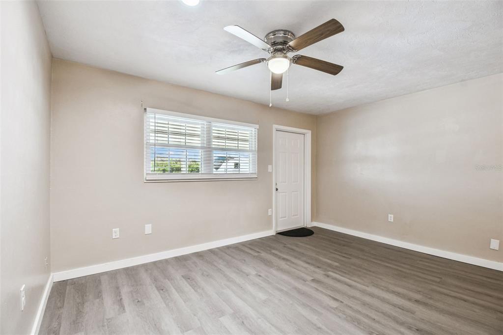 337 4th Street West, Unit A Palmetto, FL 34221 - Photo 19 of 25 an empty room with wooden floor and windows