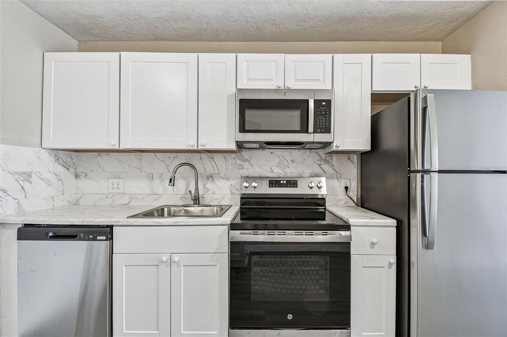 337 4th Street West, Unit A Palmetto, FL 34221 - Photo 21 of 25 a kitchen with a sink stove and refrigerator