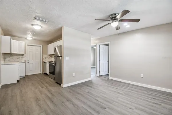 a view of a kitchen with a sink and a refrigerator
