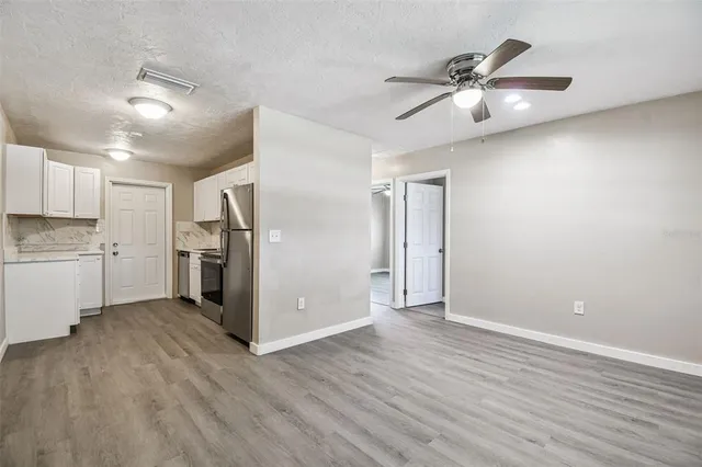 a view of a kitchen with a sink and a refrigerator