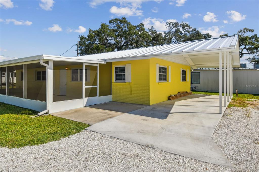 337 4th Street West, Unit A Palmetto, FL 34221 - Photo 3 of 25 a front view of a house with a yard and potted plants