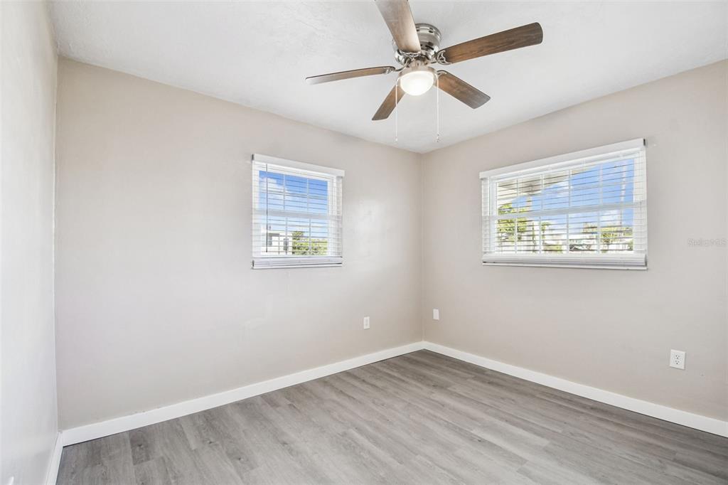 337 4th Street West, Unit A Palmetto, FL 34221 - Photo 5 of 25 an empty room with wooden floor and ceiling fan
