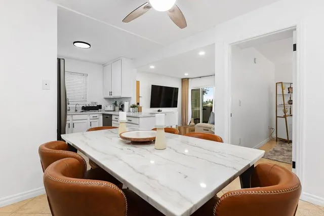 a kitchen with granite countertop a refrigerator stove top oven and sink