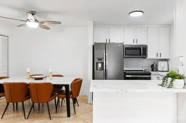a kitchen with a sink and a potted plant