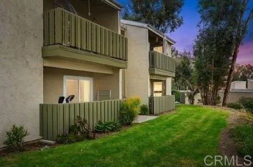 a view of a house with a small yard and plants