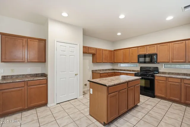 a view of a kitchen with furniture and an empty room