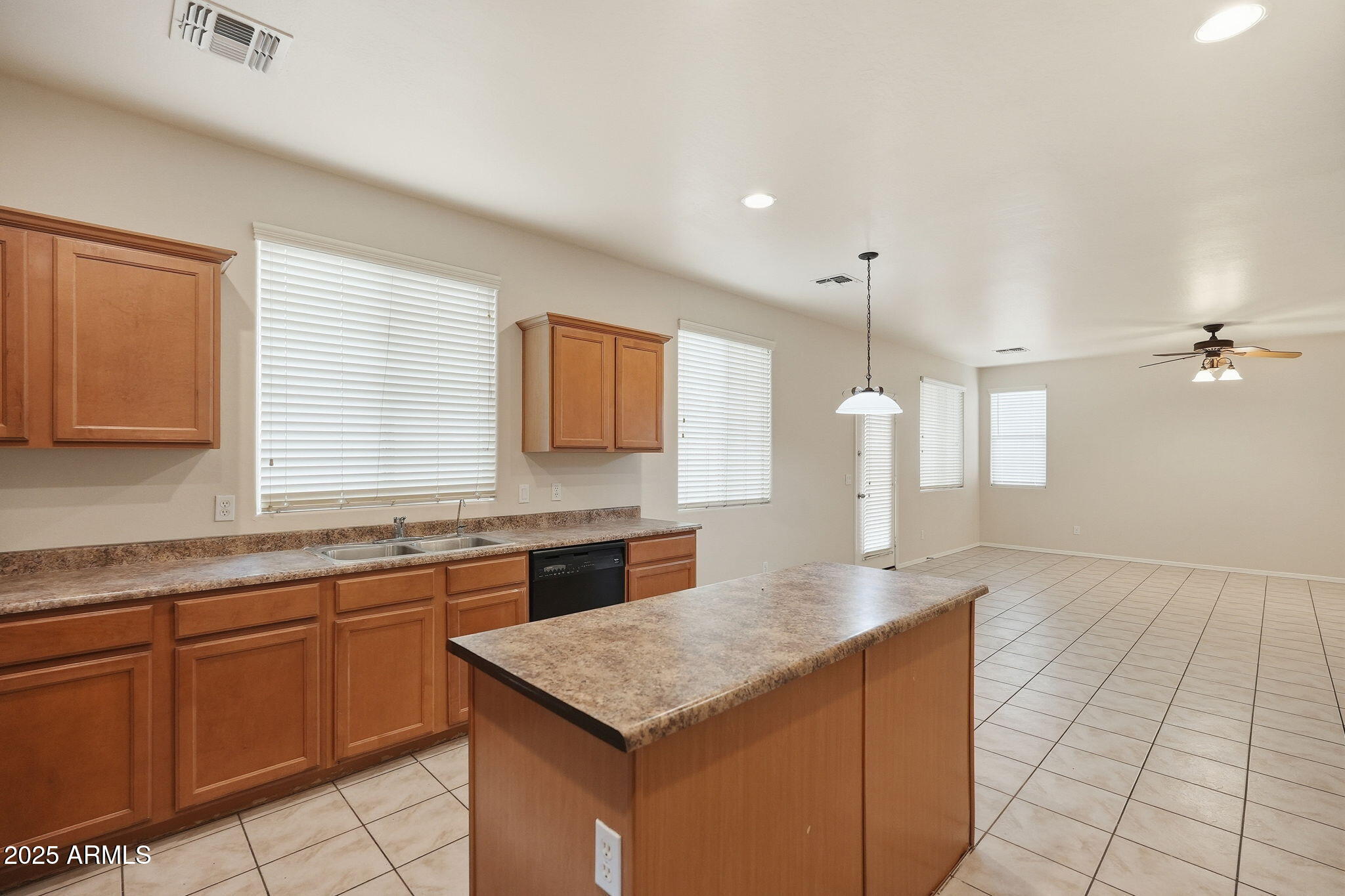 26913 North 85th Drive Peoria, AZ 85383 - Photo 16 of 48 a kitchen with stainless steel appliances granite countertop a sink and dishwasher stove with wooden cabinets
