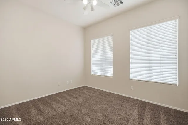 a view of a room with window and chandelier fan