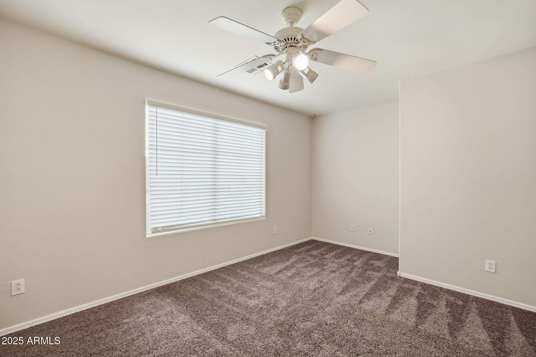 26913 North 85th Drive Peoria, AZ 85383 - Photo 23 of 48 an empty room with a chandelier fan