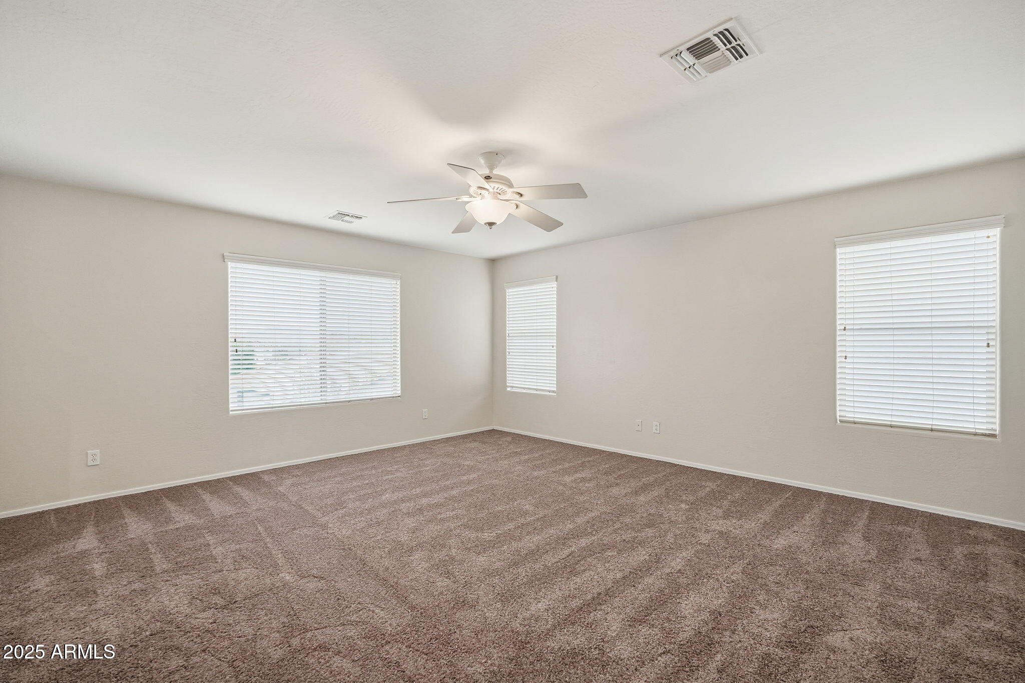 26913 North 85th Drive Peoria, AZ 85383 - Photo 25 of 48 an empty room with windows and chandelier fan