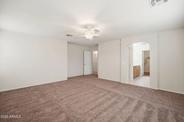 an empty room with a empty space and a ceiling fan