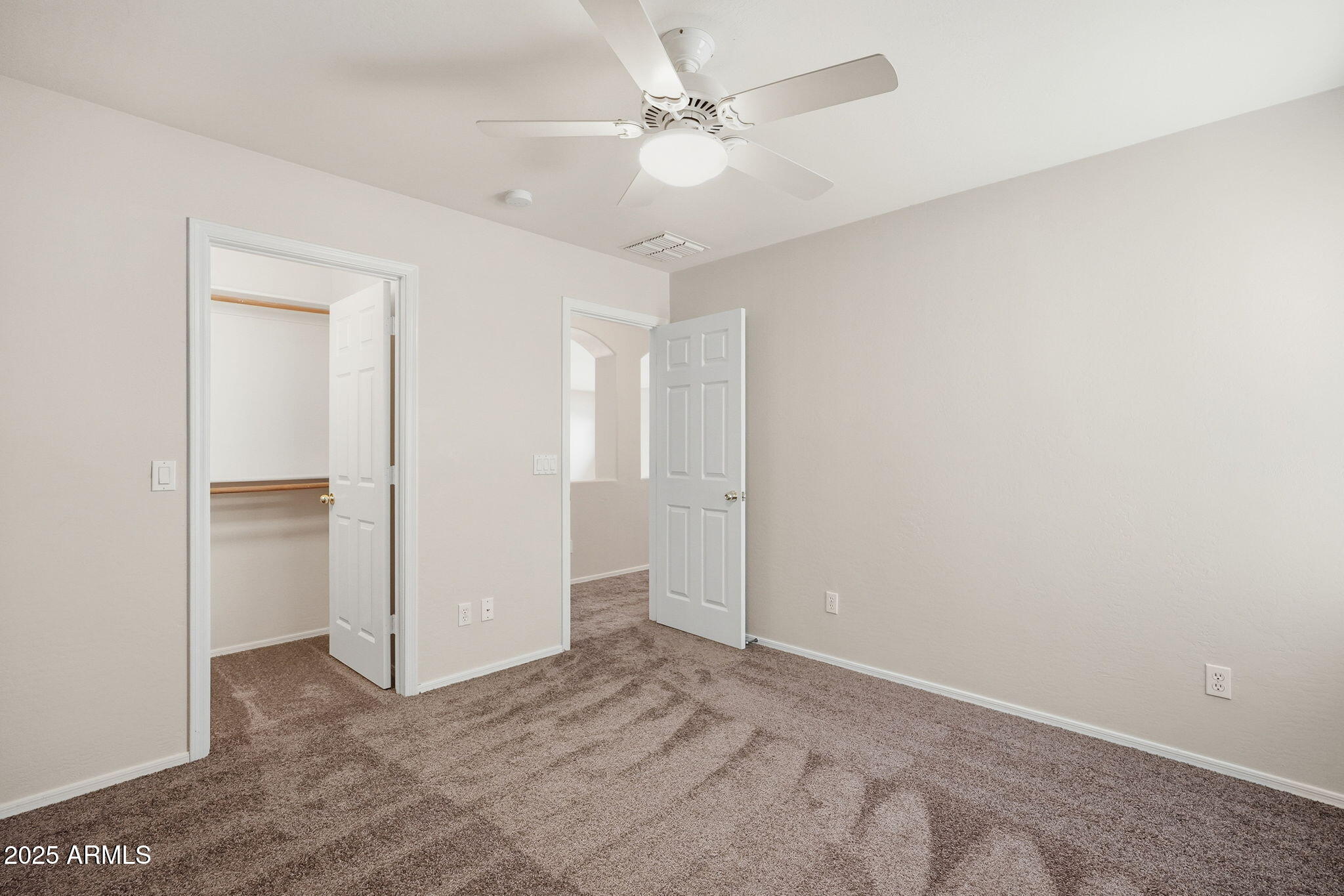 26913 North 85th Drive Peoria, AZ 85383 - Photo 30 of 48 an empty room with closet and a ceiling fan