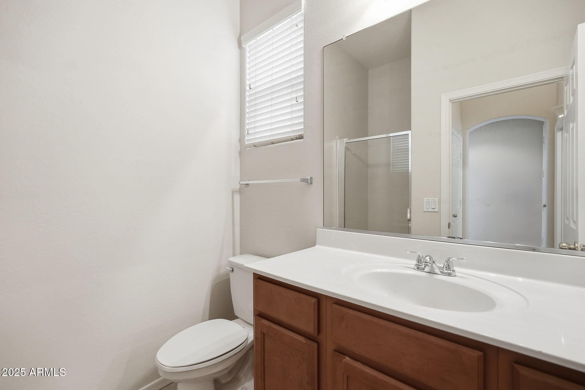 26913 North 85th Drive Peoria, AZ 85383 - Photo 35 of 48 a bathroom with a sink a toilet a mirror and shower