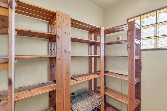 a room with rack on the wall and a window