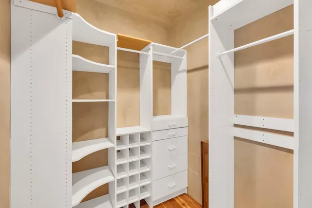 a bathroom with a granite countertop sink a mirror and a shower