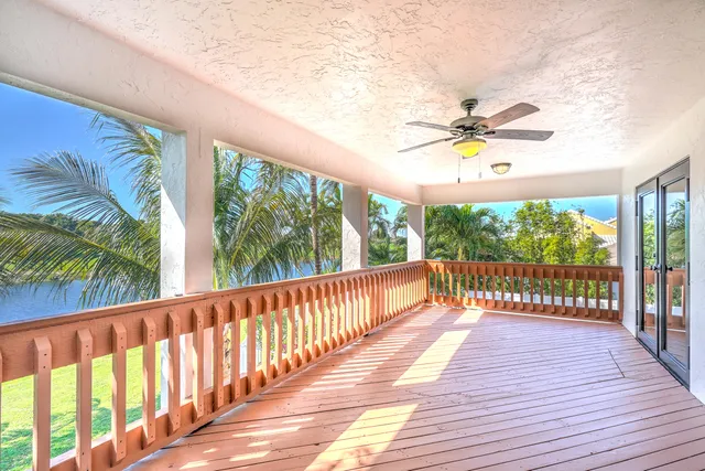 a view of a lake with a big yard and palm trees