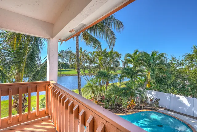 a view of a house and a yard and tree s