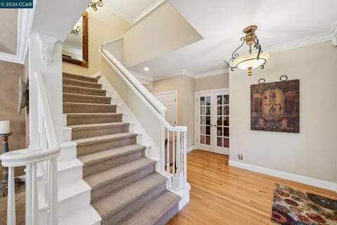 a kitchen with stainless steel appliances granite countertop a sink a stove and cabinets