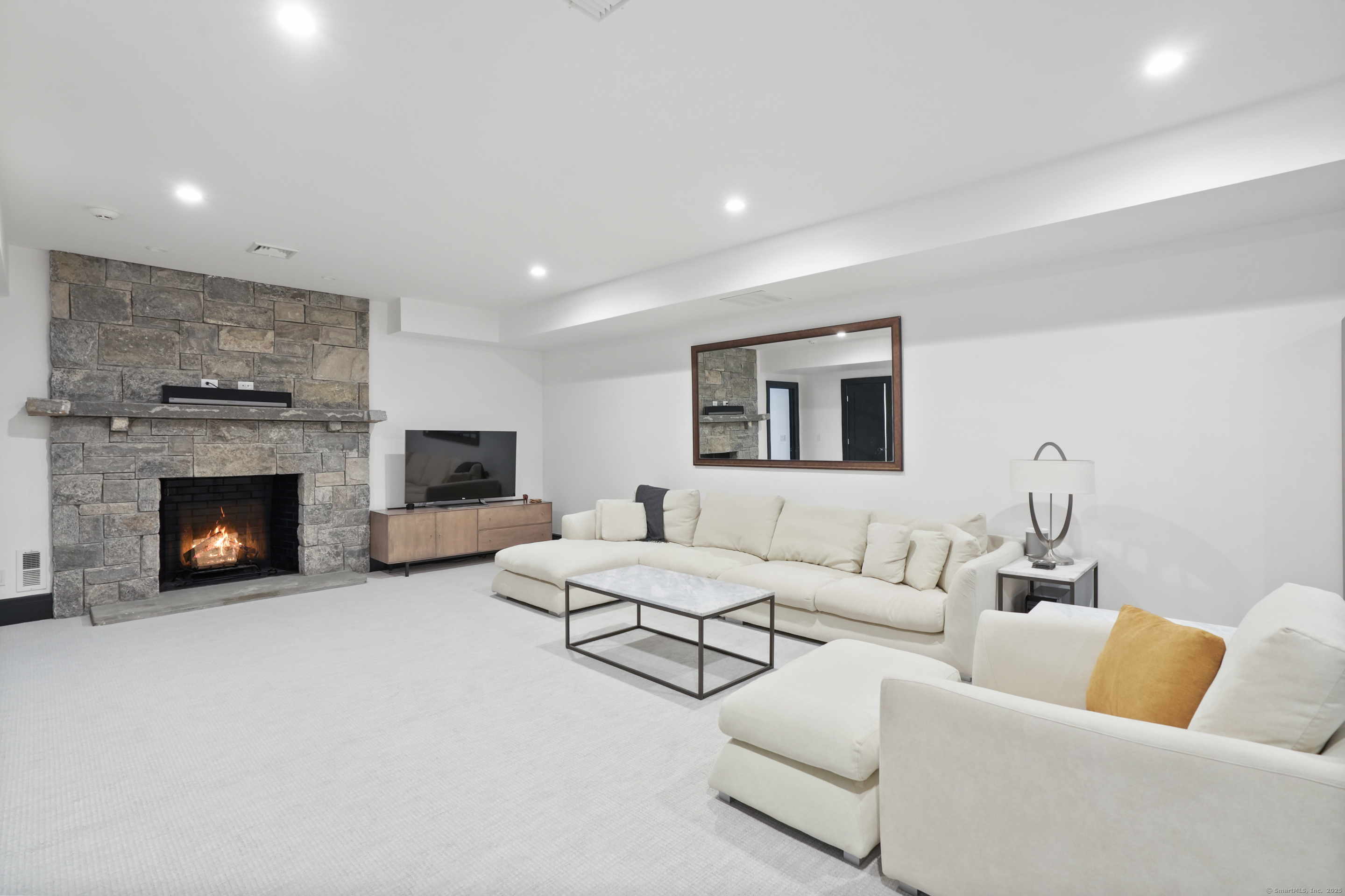 9 Burr Farms Road Westport, CT 06880 - Photo 28 of 40 a living room with furniture and a fireplace
