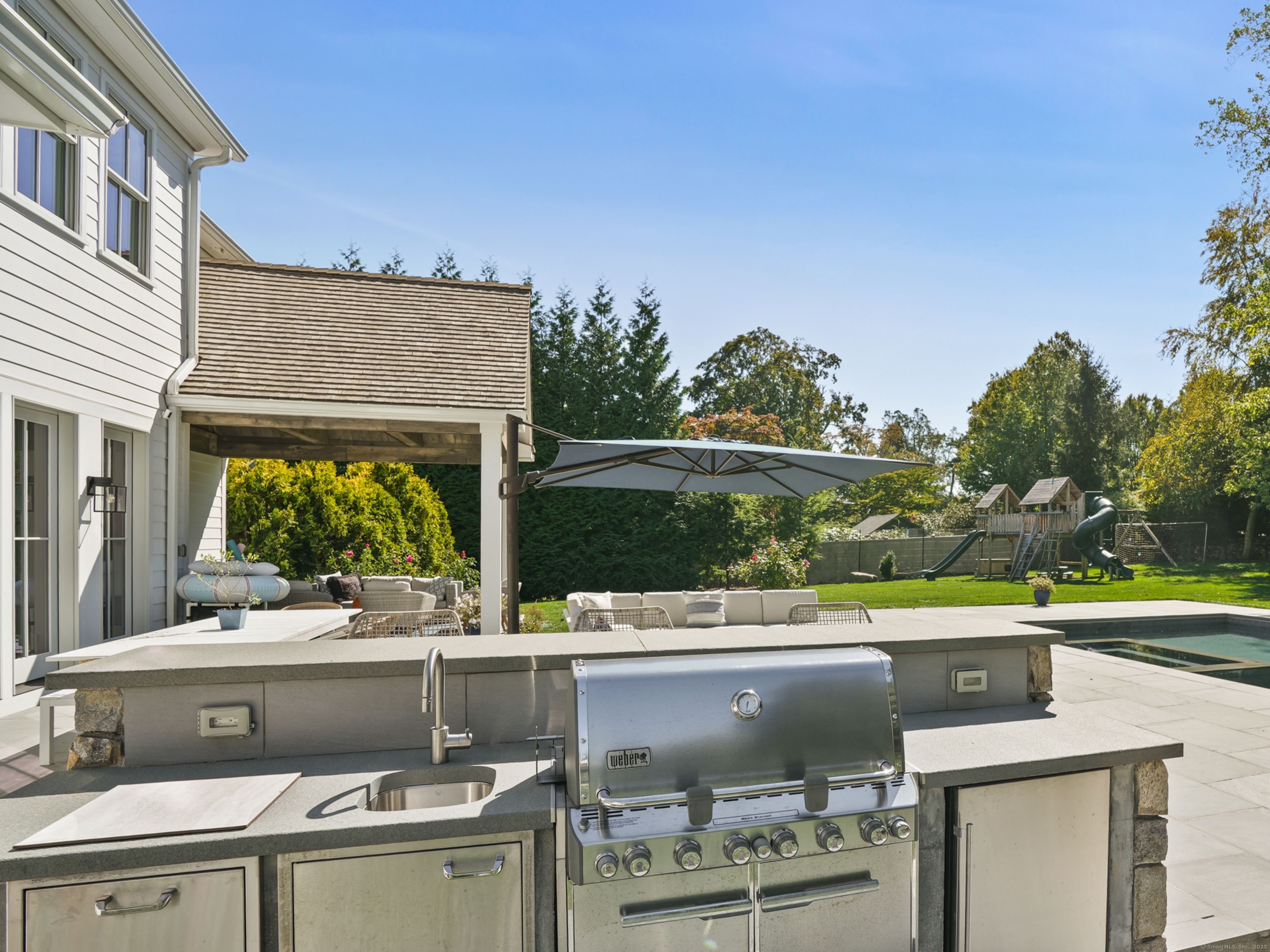 9 Burr Farms Road Westport, CT 06880 - Photo 33 of 40 a view of a terrace with a table and chairs
