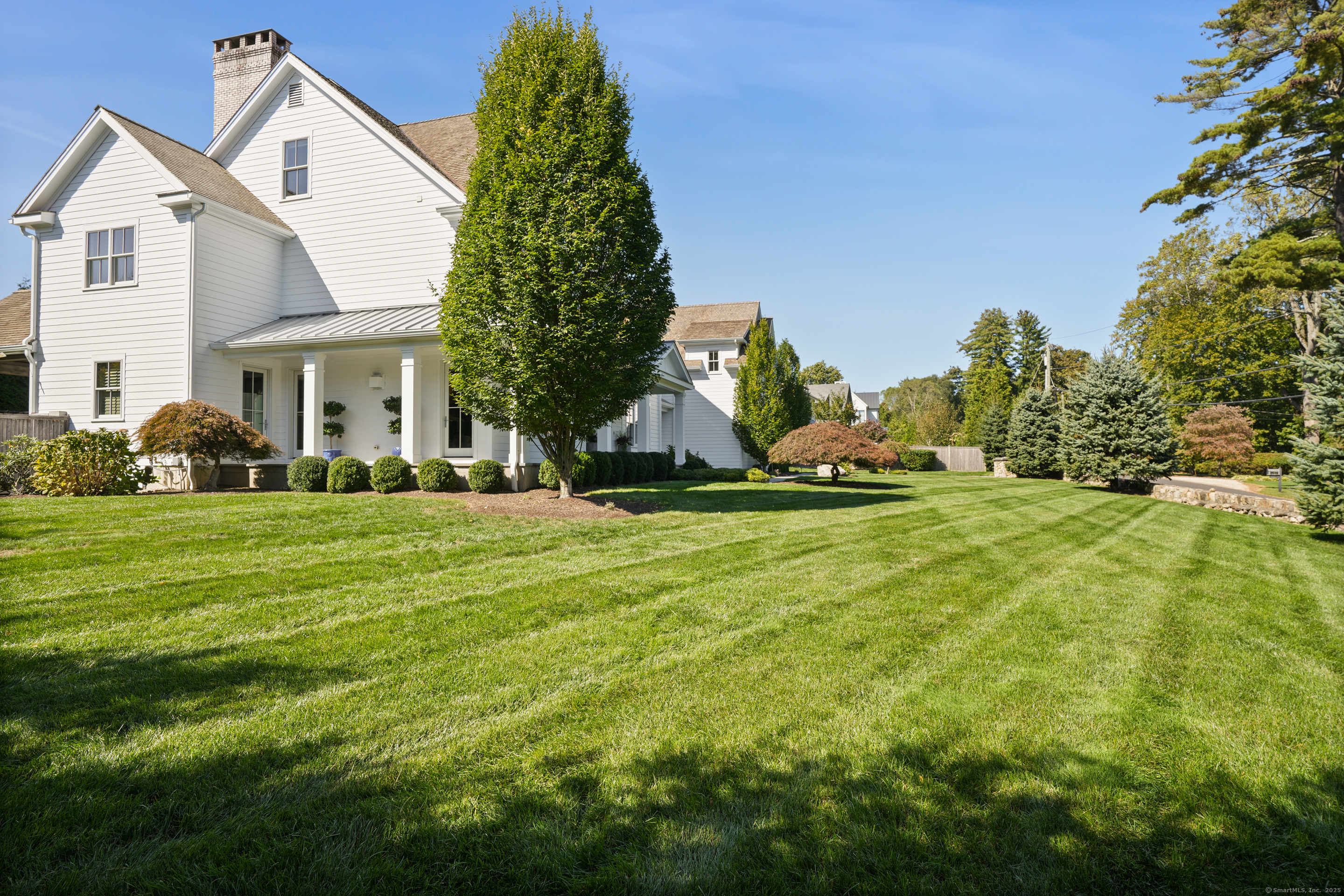9 Burr Farms Road Westport, CT 06880 - Photo 36 of 40 a front view of a house with a yard