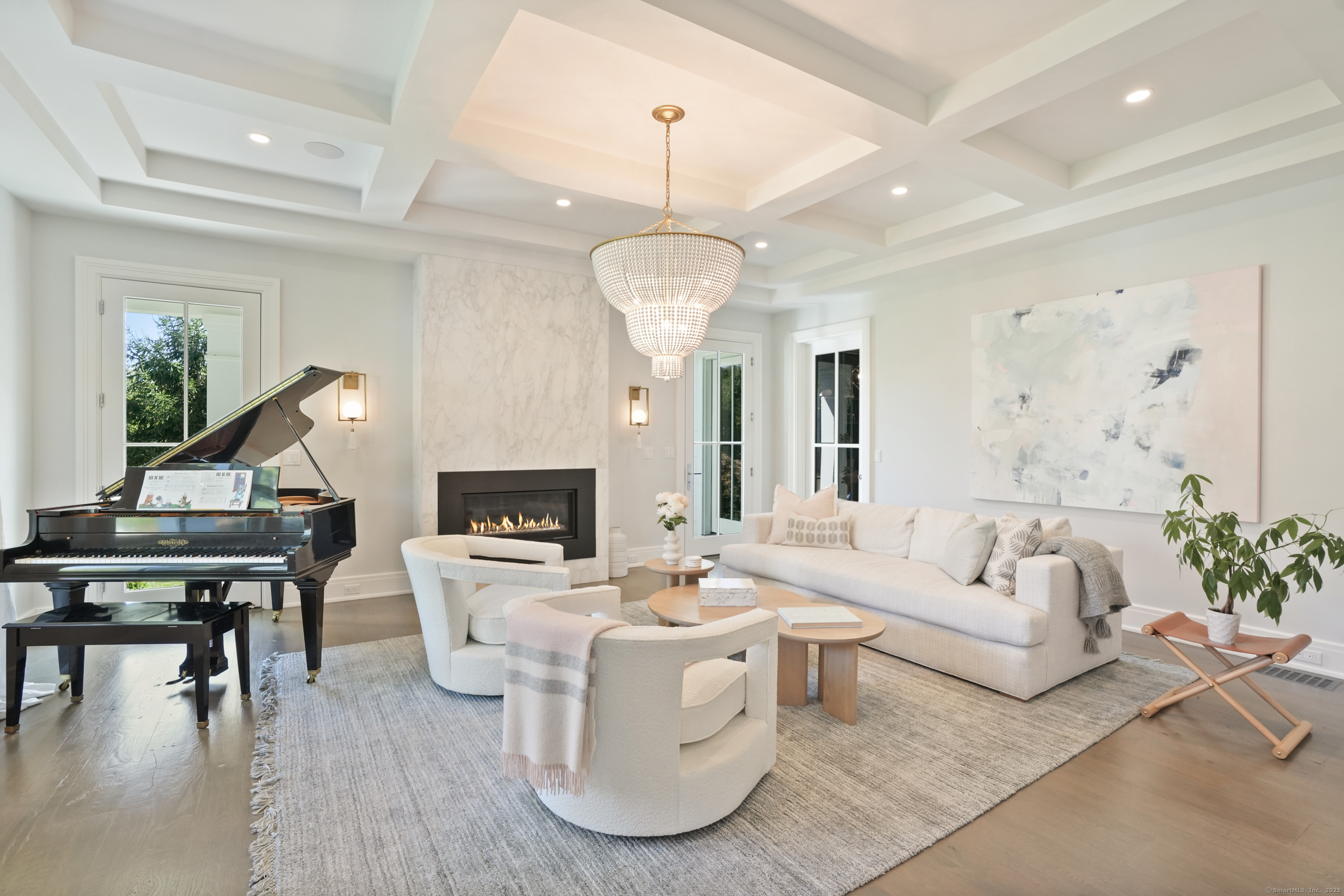 9 Burr Farms Road Westport, CT 06880 - Photo 4 of 40 a living room with furniture a fireplace and a chandelier