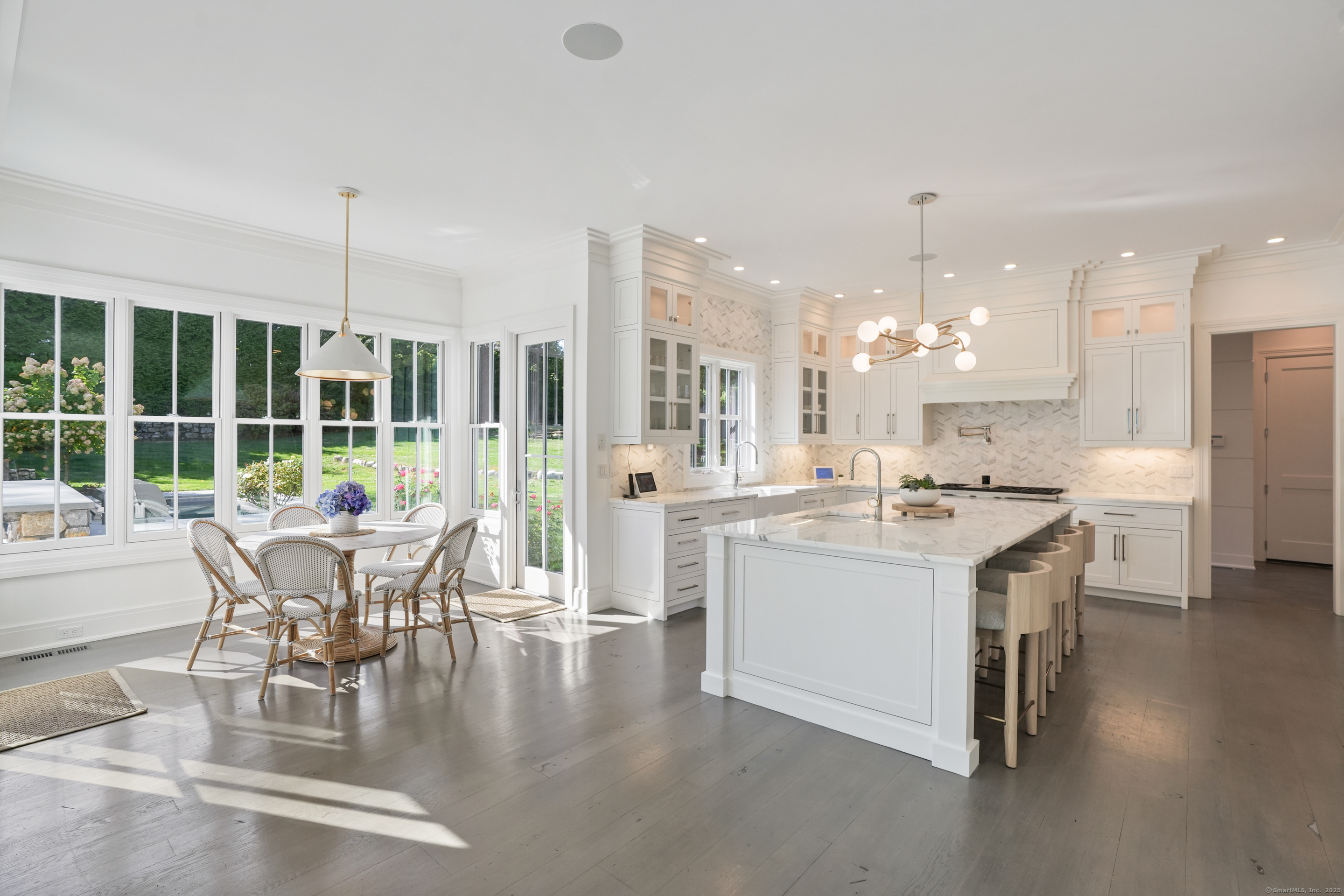 9 Burr Farms Road Westport, CT 06880 - Photo 7 of 40 a dining room with furniture a chandelier and wooden floor