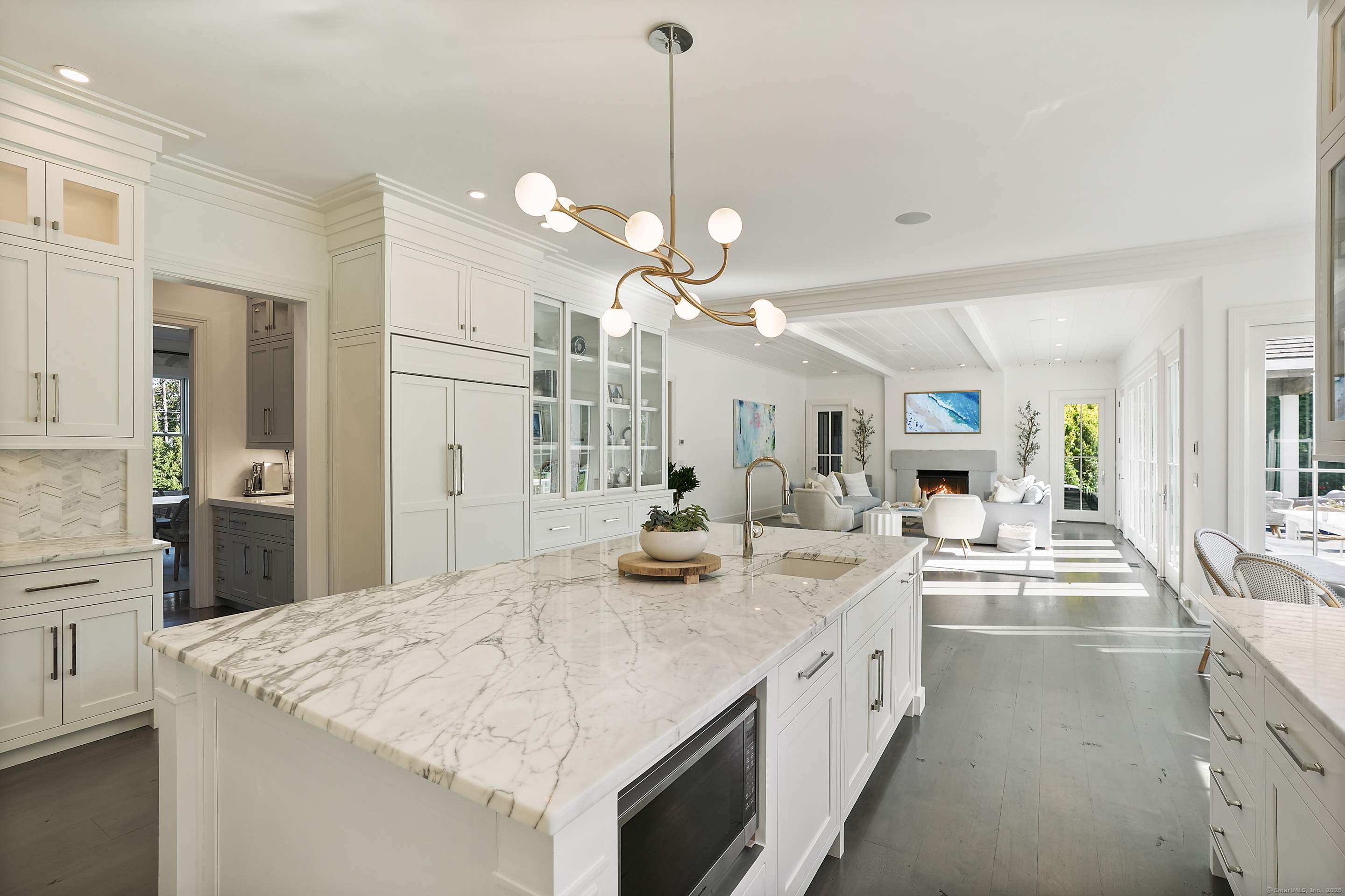 9 Burr Farms Road Westport, CT 06880 - Photo 8 of 40 a large white kitchen with a sink and dishwasher with white cabinets