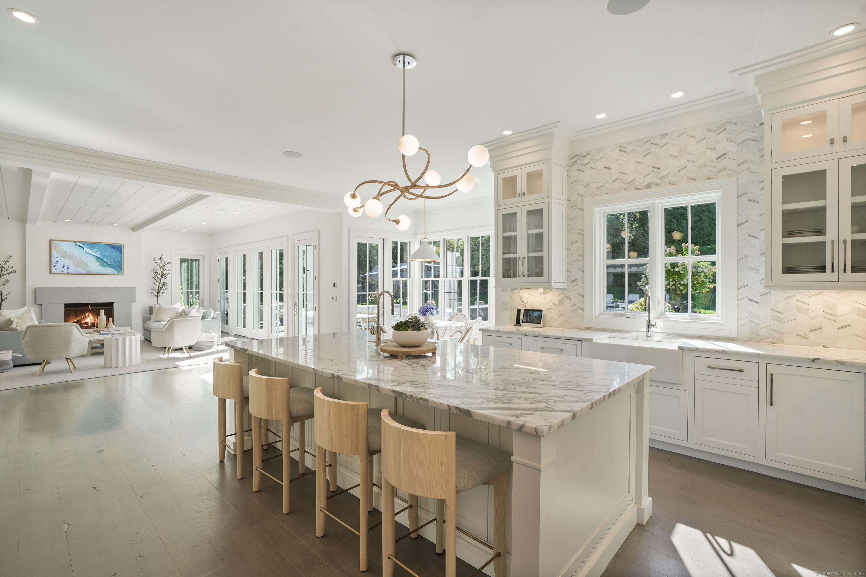 9 Burr Farms Road Westport, CT 06880 - Photo 9 of 40 a kitchen with center island table and chairs in it