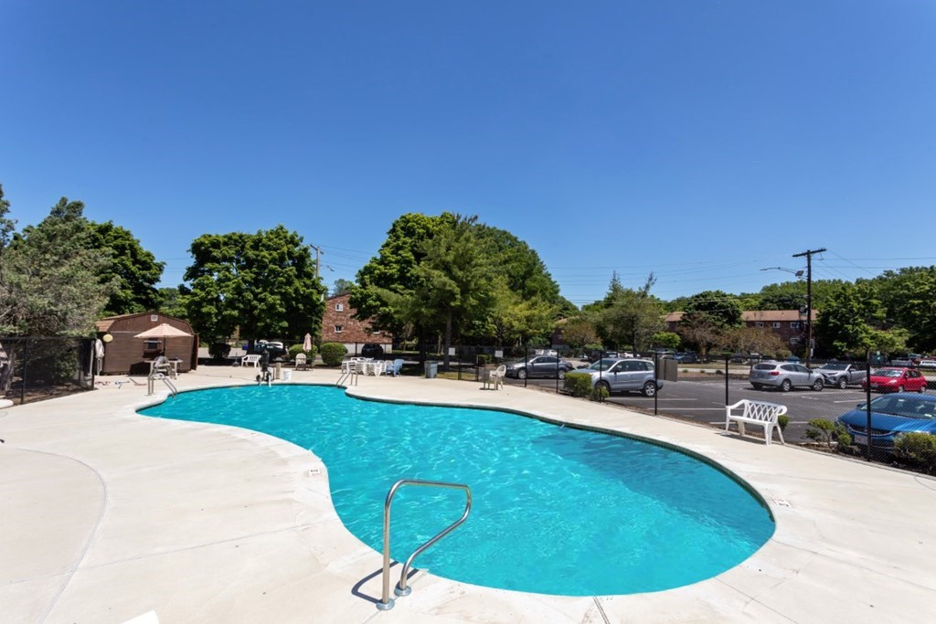 68 Bryon Road, Unit 2 Boston, MA 02467 - Photo 17 of 18 a view of a swimming pool and lounge chairs