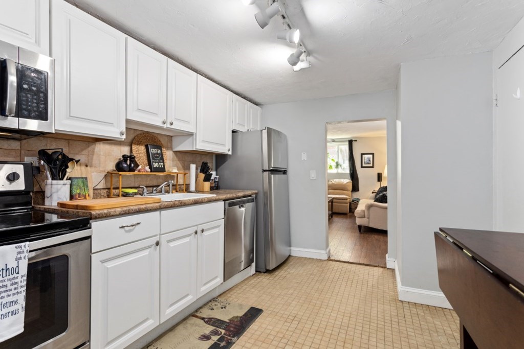 68 Bryon Road, Unit 2 Boston, MA 02467 - Photo 3 of 18 a kitchen with a refrigerator and cabinets