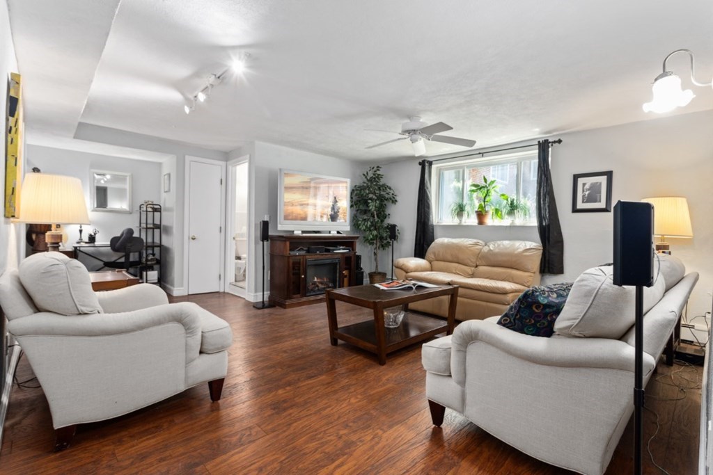 68 Bryon Road, Unit 2 Boston, MA 02467 - Photo 5 of 18 a living room with furniture and a wooden floor