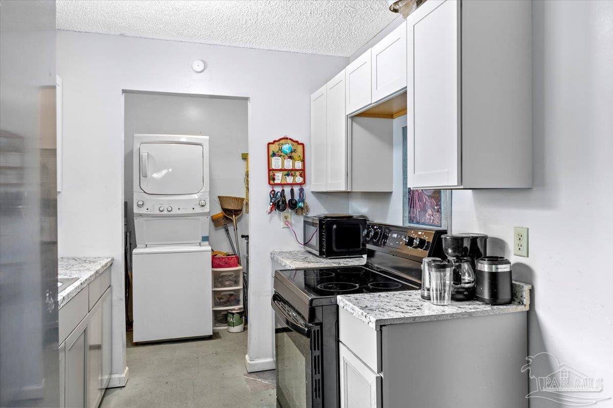 3060 Safronia Shores Road Navarre, FL 32566 - Photo 15 of 28 a kitchen that has a sink and a stove in it