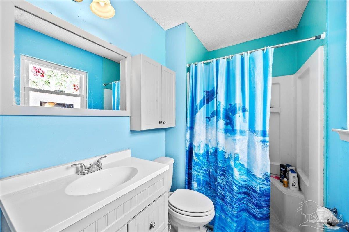 3060 Safronia Shores Road Navarre, FL 32566 - Photo 16 of 28 a bathroom with a sink toilet and shower